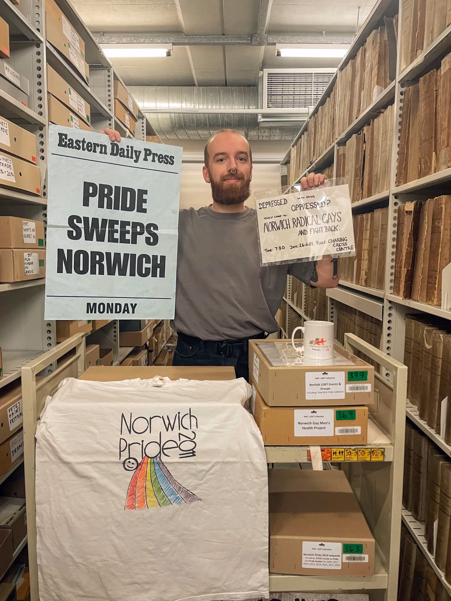 Person holding Pride Sweeps Norwich poster